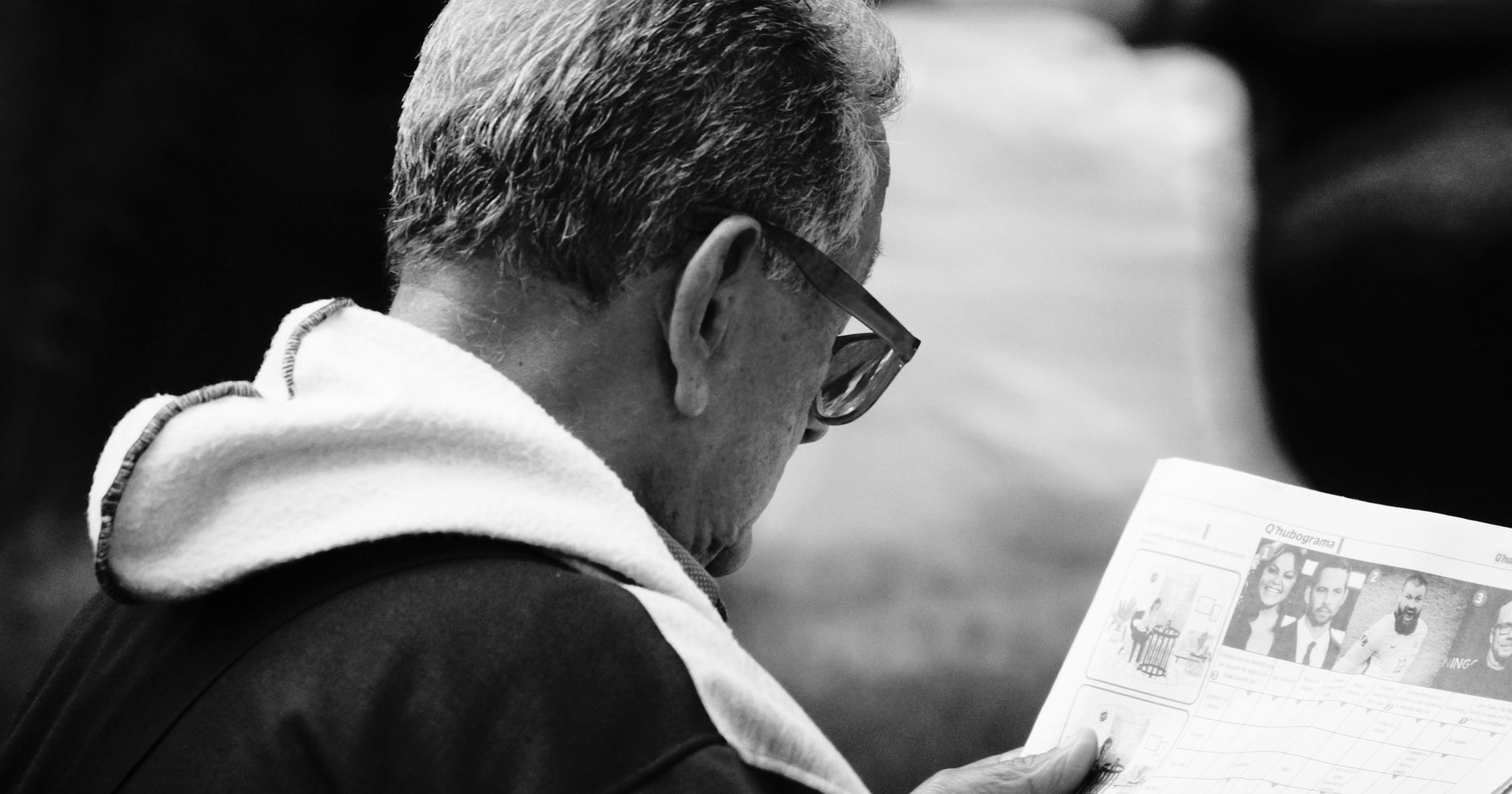 Older couple reviewing retirement account statements and a calculator at a kitchen table